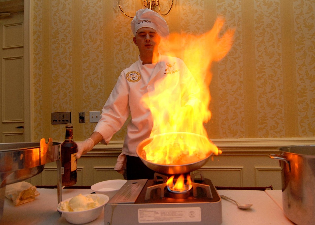 Professional chef preparing steak in restaurant kitchen